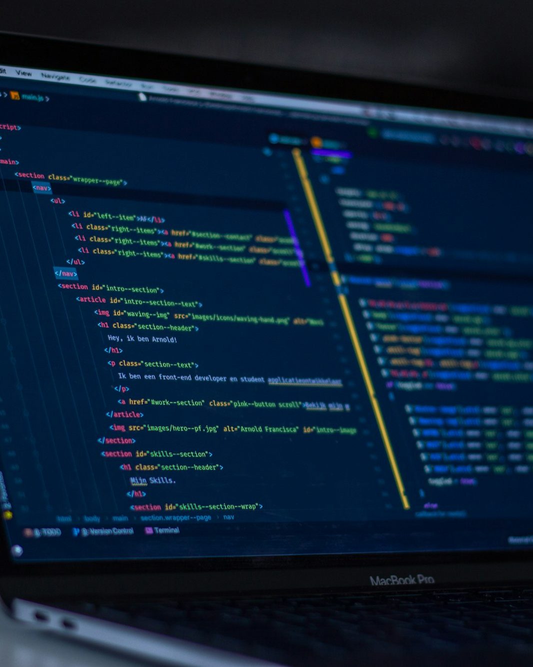 Developer workstation showing backend source code on a monitor